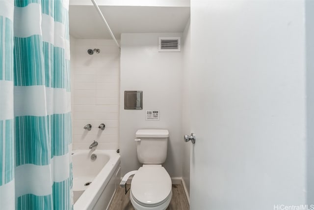 bathroom featuring shower / bathtub combination with curtain, toilet, and wood-type flooring