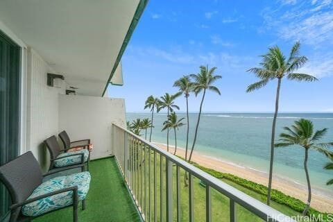 balcony with a view of the beach and a water view