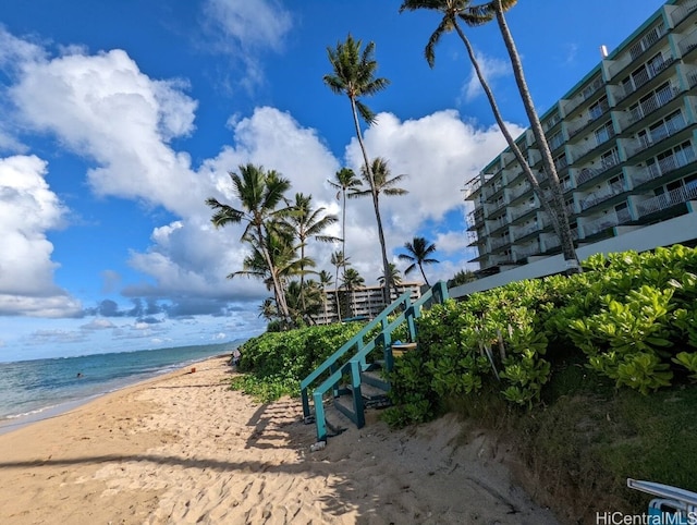 view of property's community featuring a view of the beach and a water view