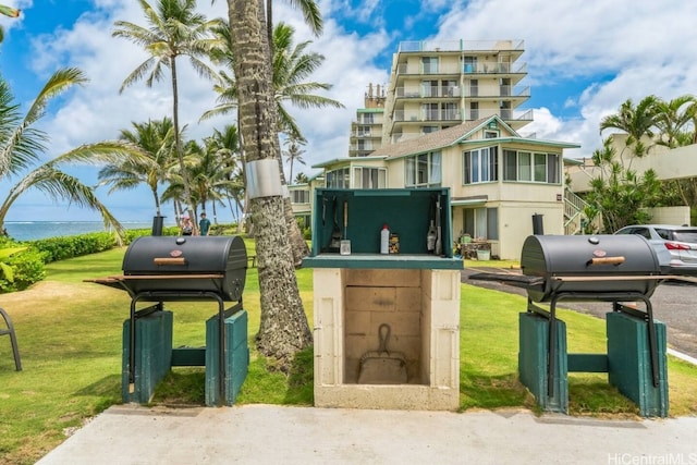 surrounding community featuring a lawn and a water view