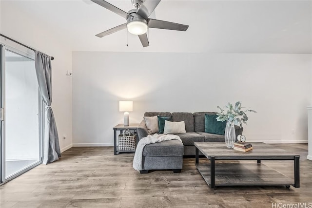 living room featuring hardwood / wood-style floors and ceiling fan