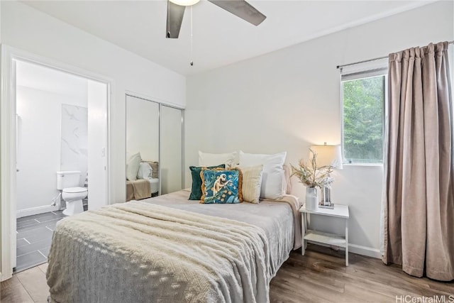 bedroom featuring a closet, ensuite bath, ceiling fan, and hardwood / wood-style floors