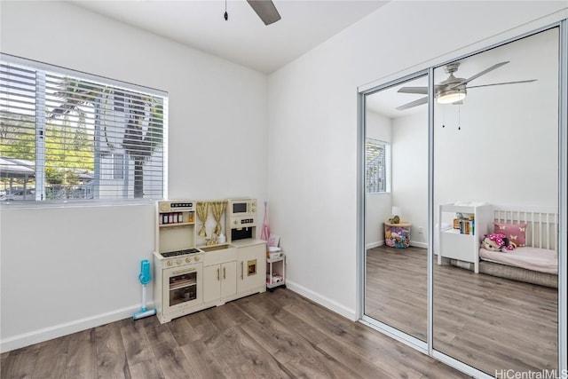 recreation room with hardwood / wood-style flooring and a healthy amount of sunlight