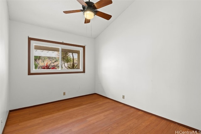 empty room featuring ceiling fan, lofted ceiling, and light hardwood / wood-style flooring