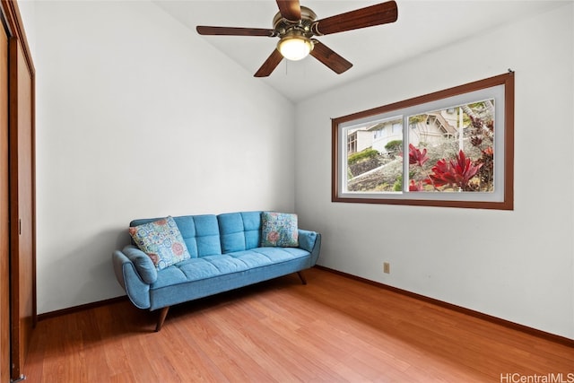 sitting room with ceiling fan, hardwood / wood-style floors, and lofted ceiling