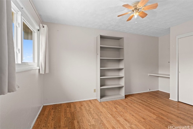 unfurnished bedroom featuring a textured ceiling, light hardwood / wood-style floors, and ceiling fan