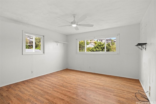 spare room featuring ceiling fan, a textured ceiling, and light wood-type flooring