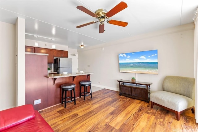 interior space featuring light hardwood / wood-style floors and ceiling fan