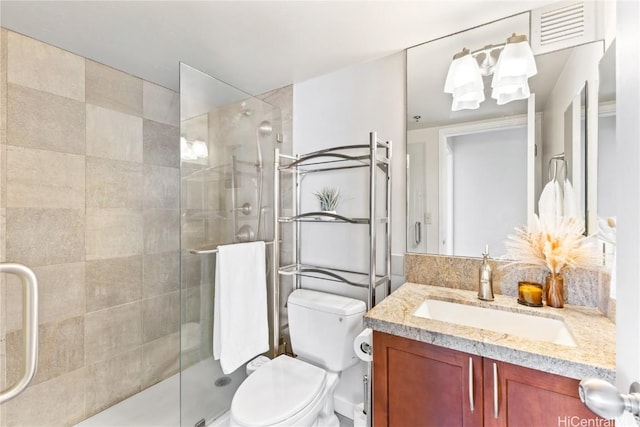 bathroom with toilet, walk in shower, and vanity