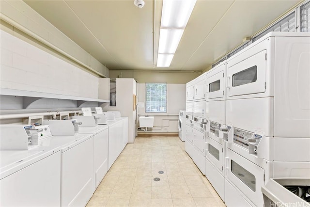 washroom with washer and dryer and stacked washing maching and dryer