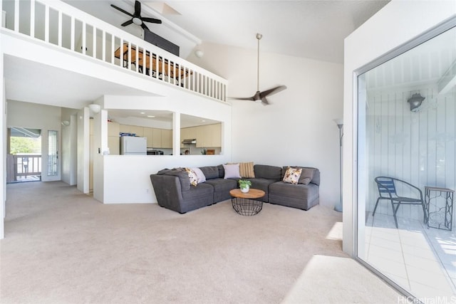 carpeted living room featuring ceiling fan and high vaulted ceiling