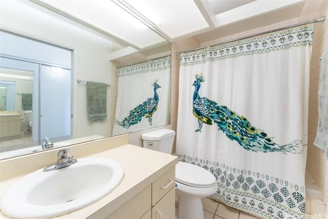 bathroom with tile patterned flooring, vanity, and toilet