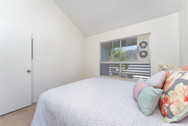 bedroom featuring carpet, lofted ceiling, and a textured ceiling