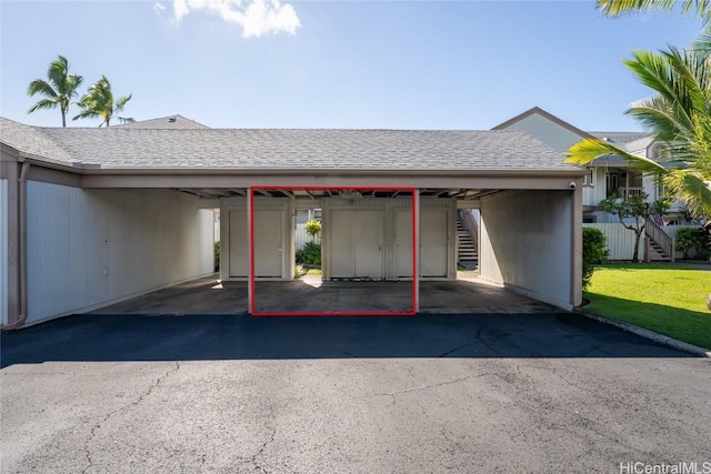 view of car parking featuring a lawn and a carport