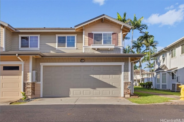 view of front of house with a garage and central AC unit