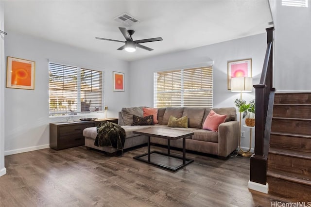 living room featuring ceiling fan, a healthy amount of sunlight, and dark hardwood / wood-style flooring