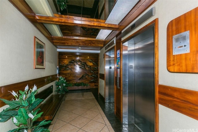 corridor with light tile patterned flooring and elevator