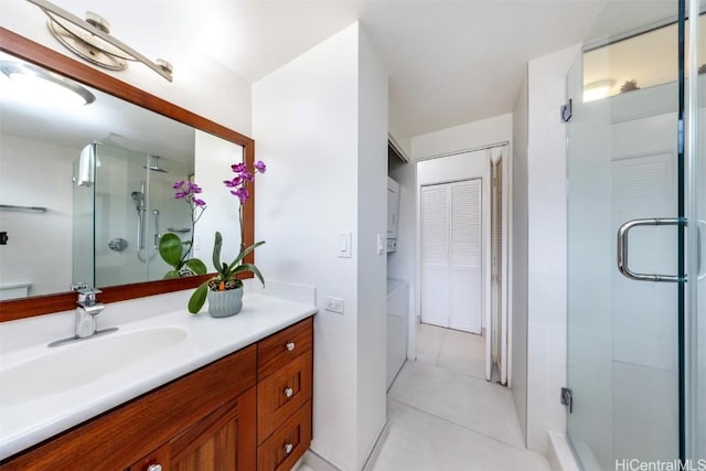 full bath with vanity, a shower stall, and tile patterned floors