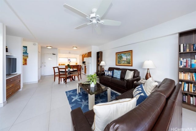 tiled living room with ceiling fan