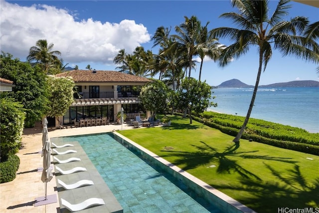 view of pool with a lawn, a water and mountain view, and a patio