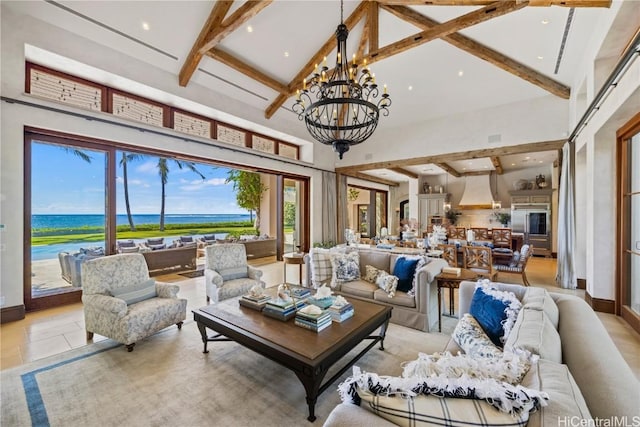 tiled living room with beam ceiling, an inviting chandelier, a water view, and high vaulted ceiling