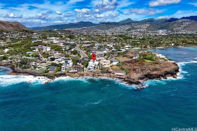 drone / aerial view featuring a water and mountain view