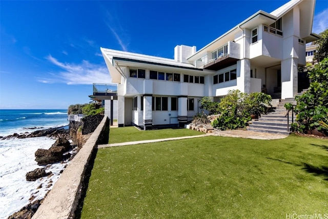 exterior space featuring a water view and a yard