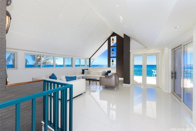 interior space featuring french doors, a water view, and light tile patterned flooring