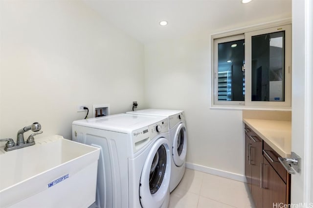 laundry area featuring washer and dryer, light tile patterned floors, cabinets, and sink