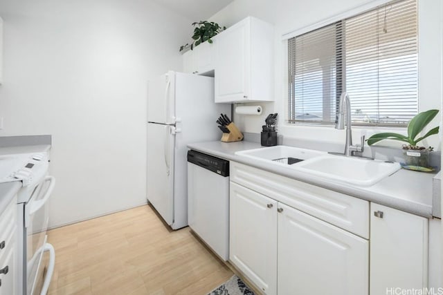 kitchen featuring white cabinetry, sink, white appliances, and light hardwood / wood-style flooring