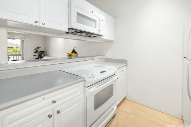 kitchen with white cabinetry, light hardwood / wood-style flooring, and white appliances