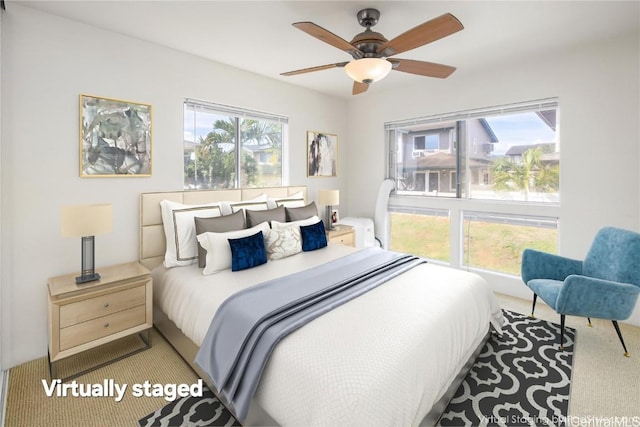 bedroom with ceiling fan and carpet floors