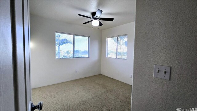 carpeted empty room with ceiling fan