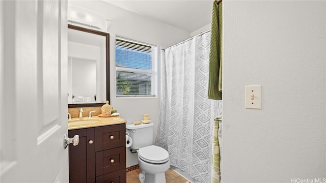 bathroom with tile patterned floors, toilet, and vanity