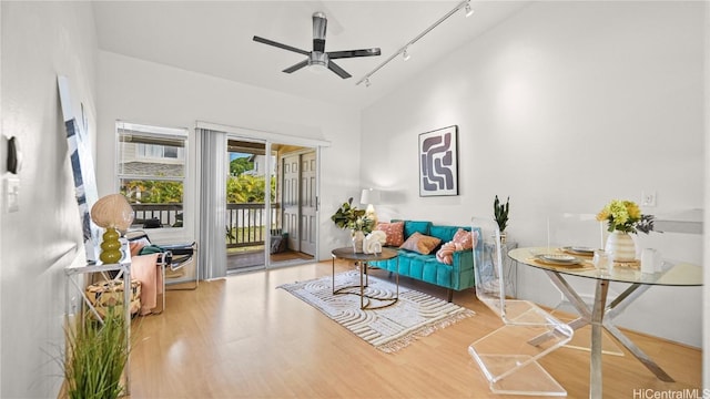 living area with rail lighting, ceiling fan, and hardwood / wood-style floors