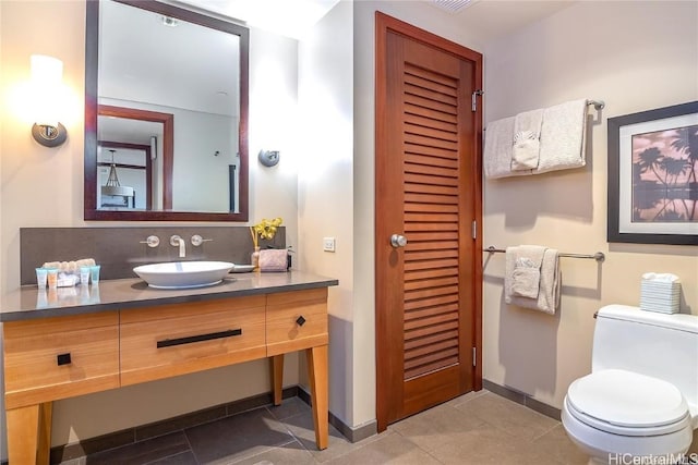 bathroom with tile patterned floors, vanity, and toilet