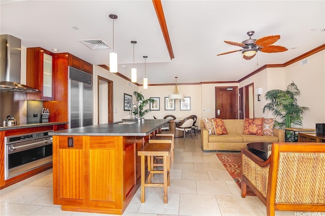 92-104 Waialii Pl Unit O523, Kapolei, HI 96707 - kitchen with stainless steel appliances, wall chimney range hood, dark countertops, a ceiling fan, and glass insert cabinets