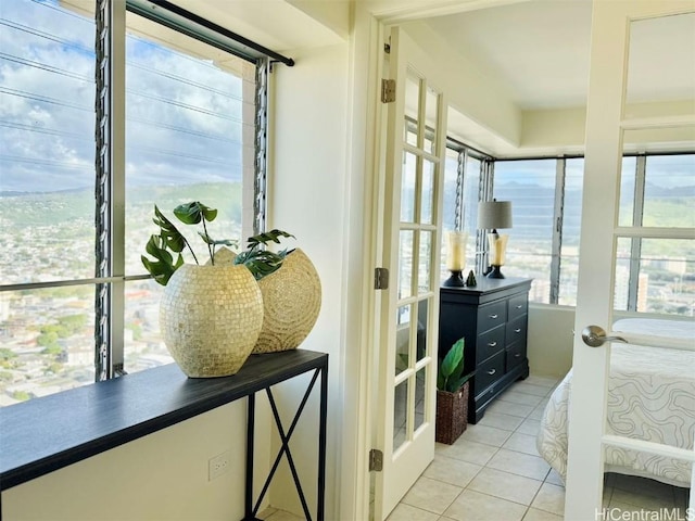 bedroom with french doors and light tile patterned flooring