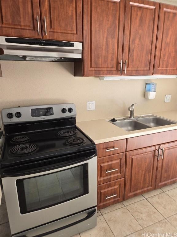 kitchen with stainless steel electric range oven, sink, and light tile patterned floors