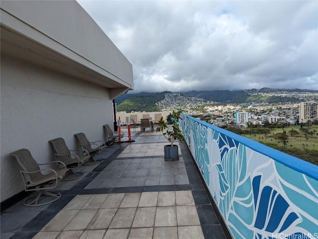 view of patio / terrace featuring a mountain view and a balcony