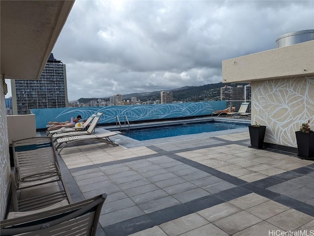 view of swimming pool featuring a patio area