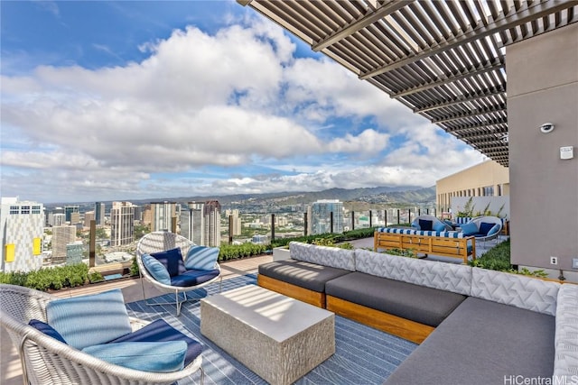 view of patio / terrace with a pergola, a mountain view, and an outdoor hangout area