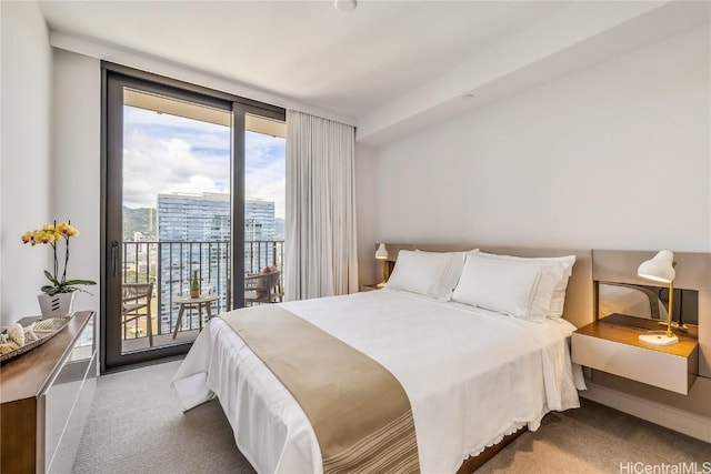 bedroom with access to exterior, carpet, and floor to ceiling windows