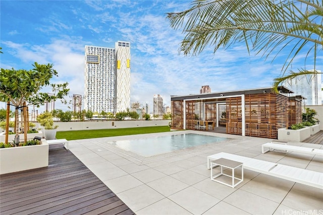 view of swimming pool with a deck and a patio area