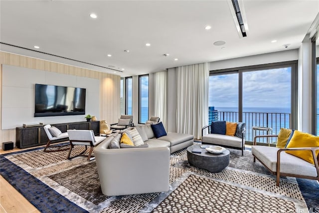 living room with a water view and hardwood / wood-style flooring