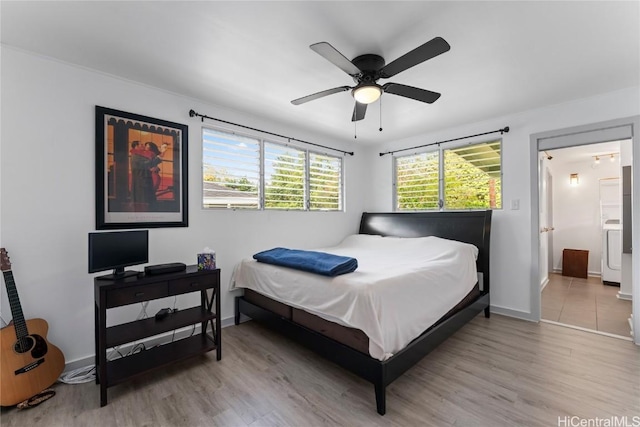 bedroom with ceiling fan, light wood-type flooring, washer / clothes dryer, and ensuite bath