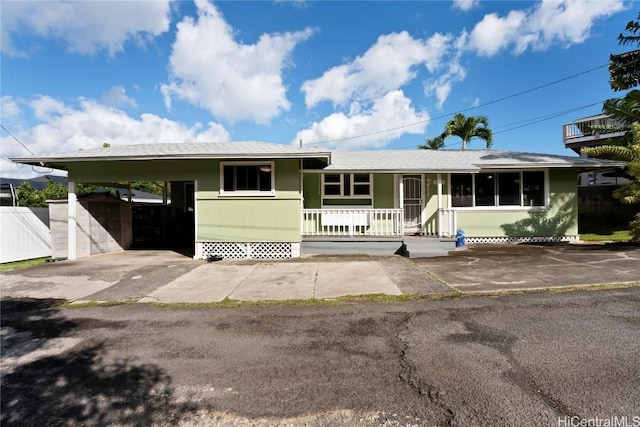 view of front of property with covered porch and a carport