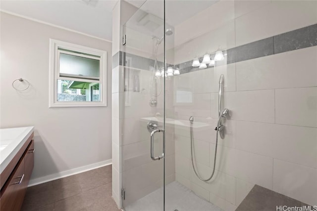 bathroom with a shower with door, vanity, and tile patterned flooring