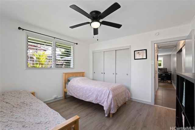 bedroom with a closet, ceiling fan, and hardwood / wood-style floors