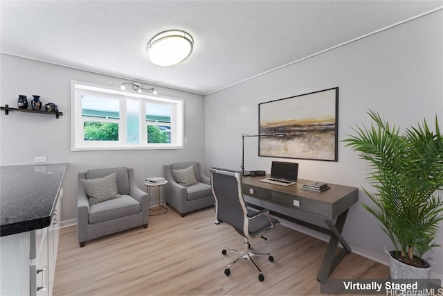 office space featuring light hardwood / wood-style floors and a textured ceiling